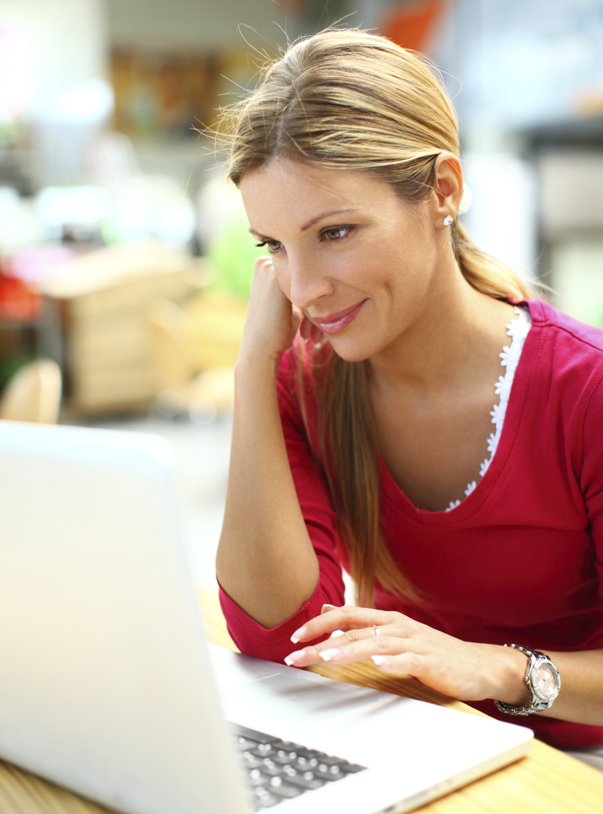 A GIS professional sits at a laptop, happily following a GIS247 training course