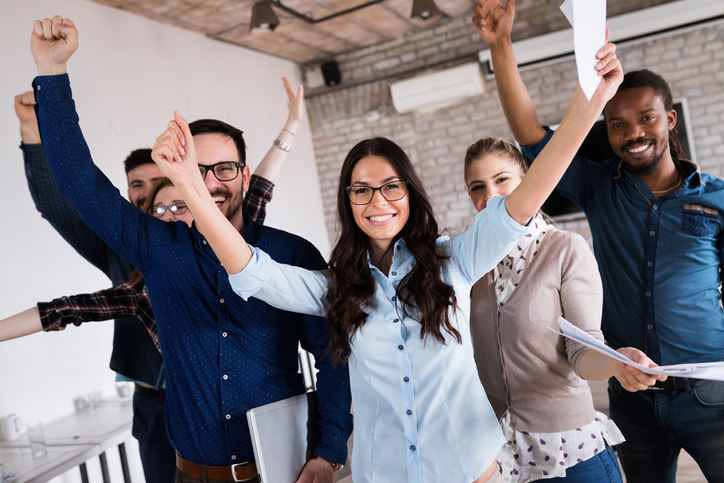 A group of people celebrate gaining their certificate for passing a GIS course